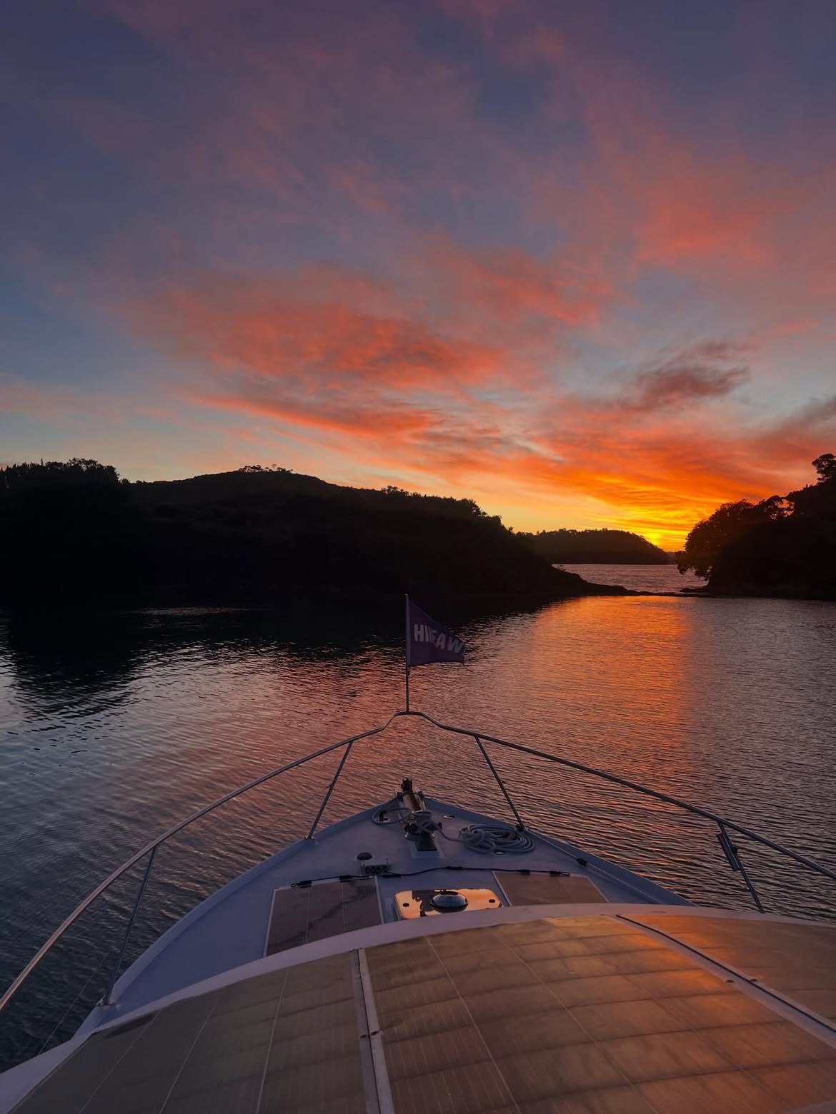 Sunrise over the water from the bow